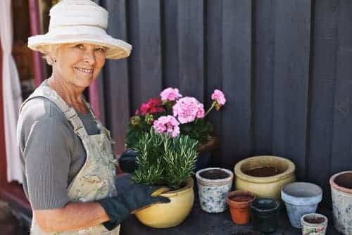 Mature woman potting plants