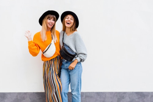 Women Standing In Front Of Wall