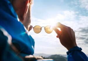 Man holding sunglasses 