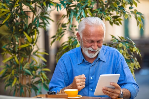 man reading book tablet 