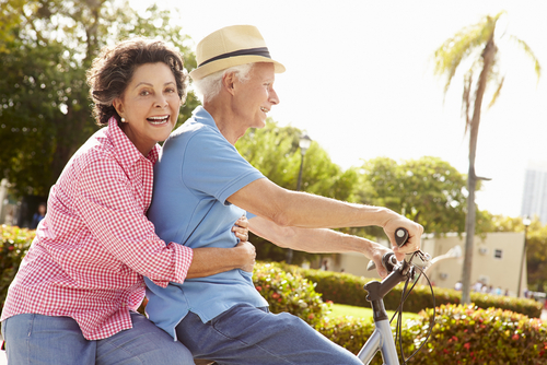 A man and women riding on a bike